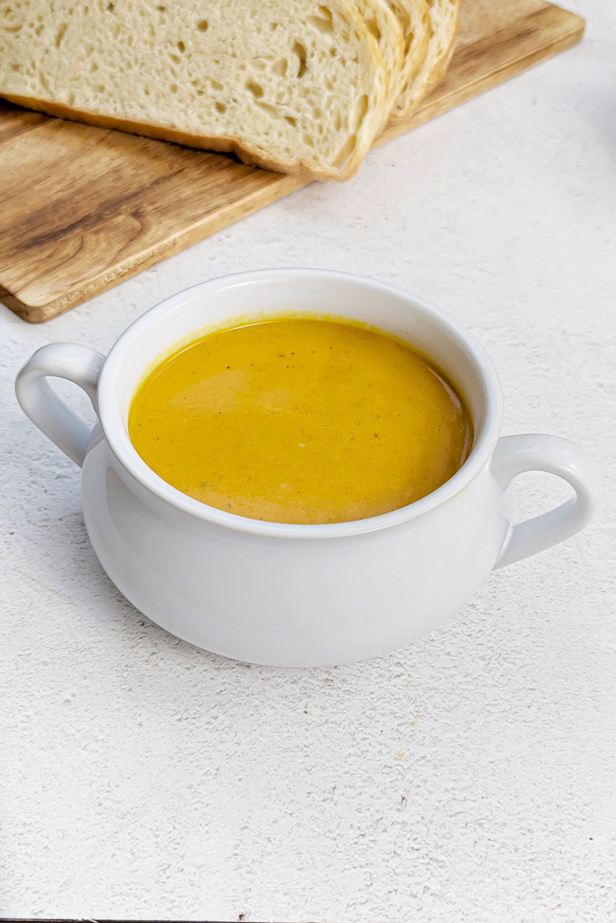Carrot pumpkin soup in soup bowls.