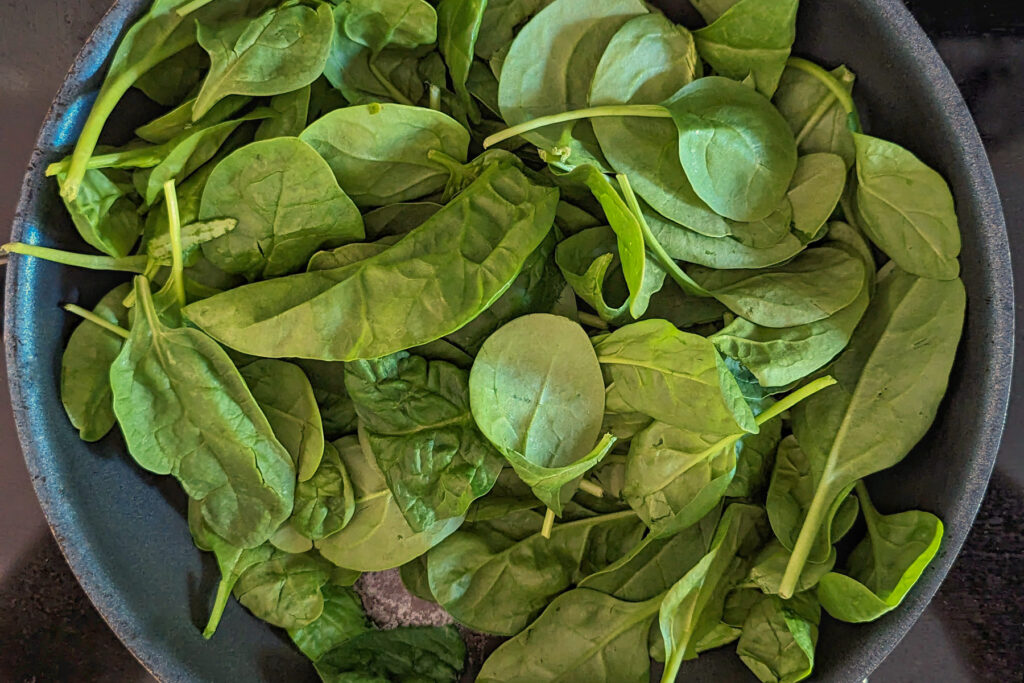 Spinach cooking in a skillet.