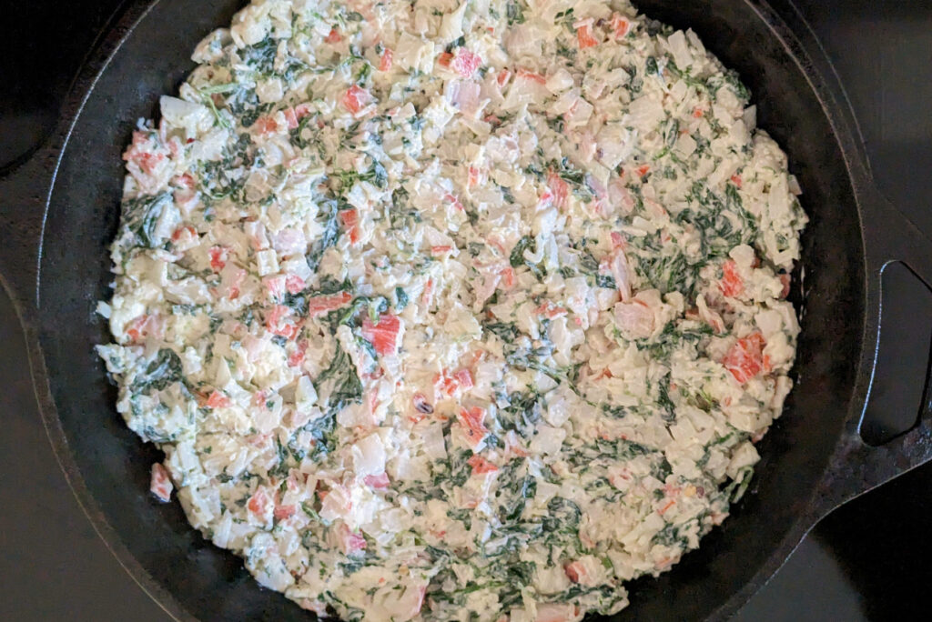 Crab spinach dip in a skillet.
