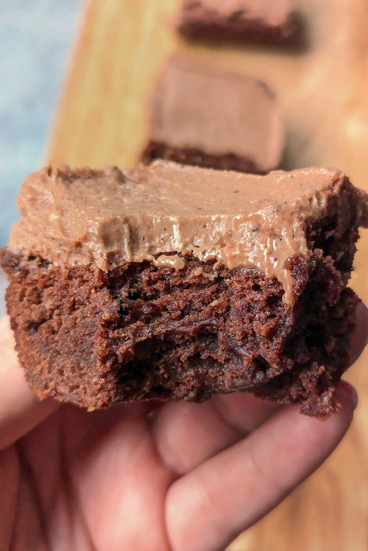 Cream cheese frosting spread onto brownies.