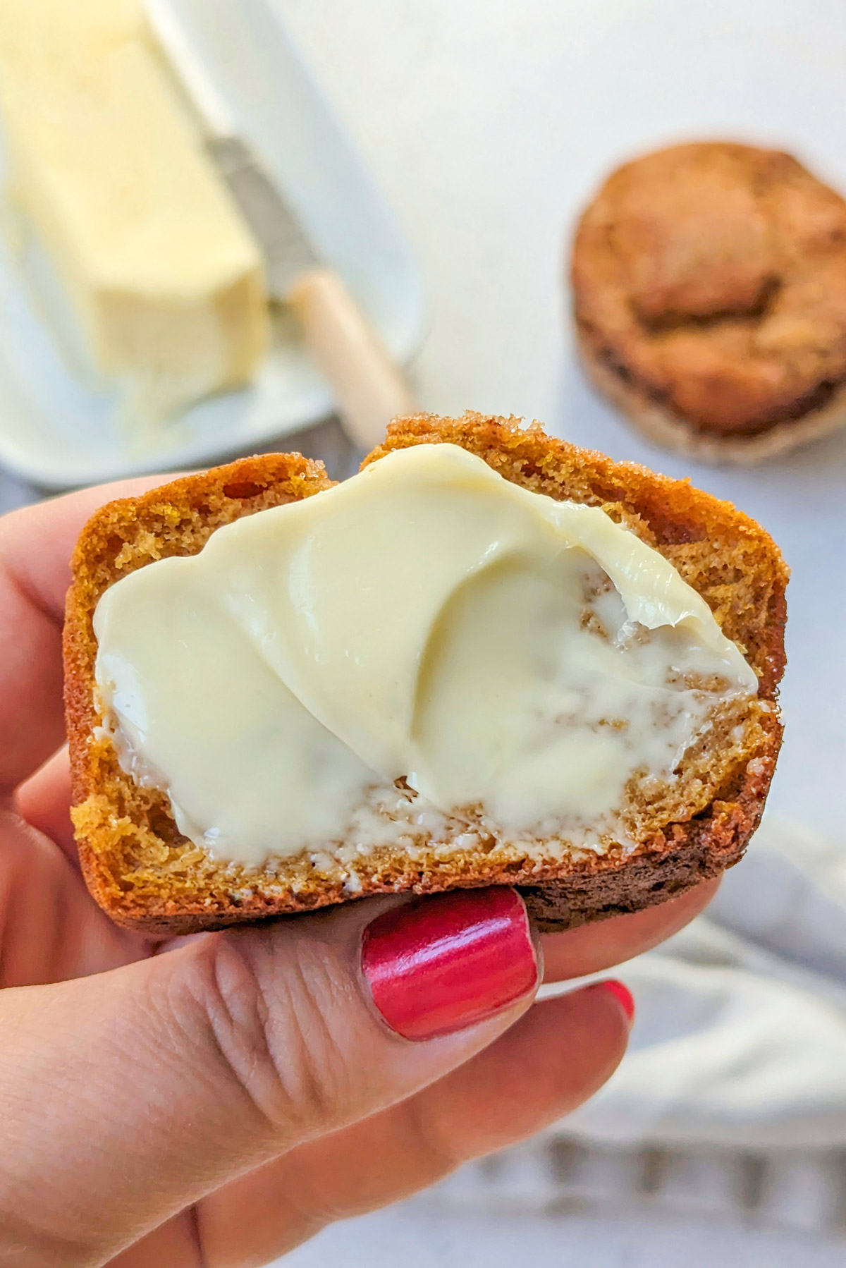 A cut open Kodiak Cakes Pumpkin Muffin with butter on it.