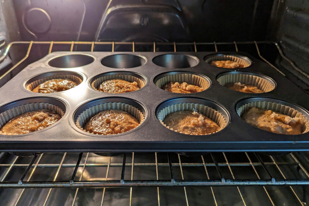 Kodiak Cakes Pumpkin Muffins baking in the oven.