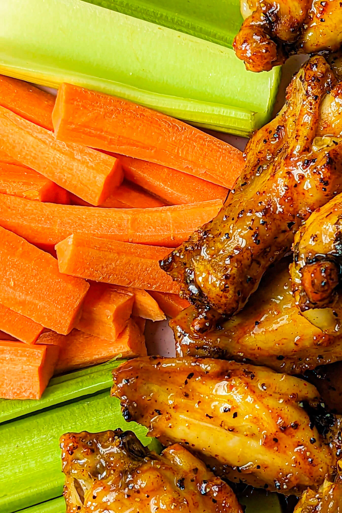 Celery and carrots on a plate with wings. 