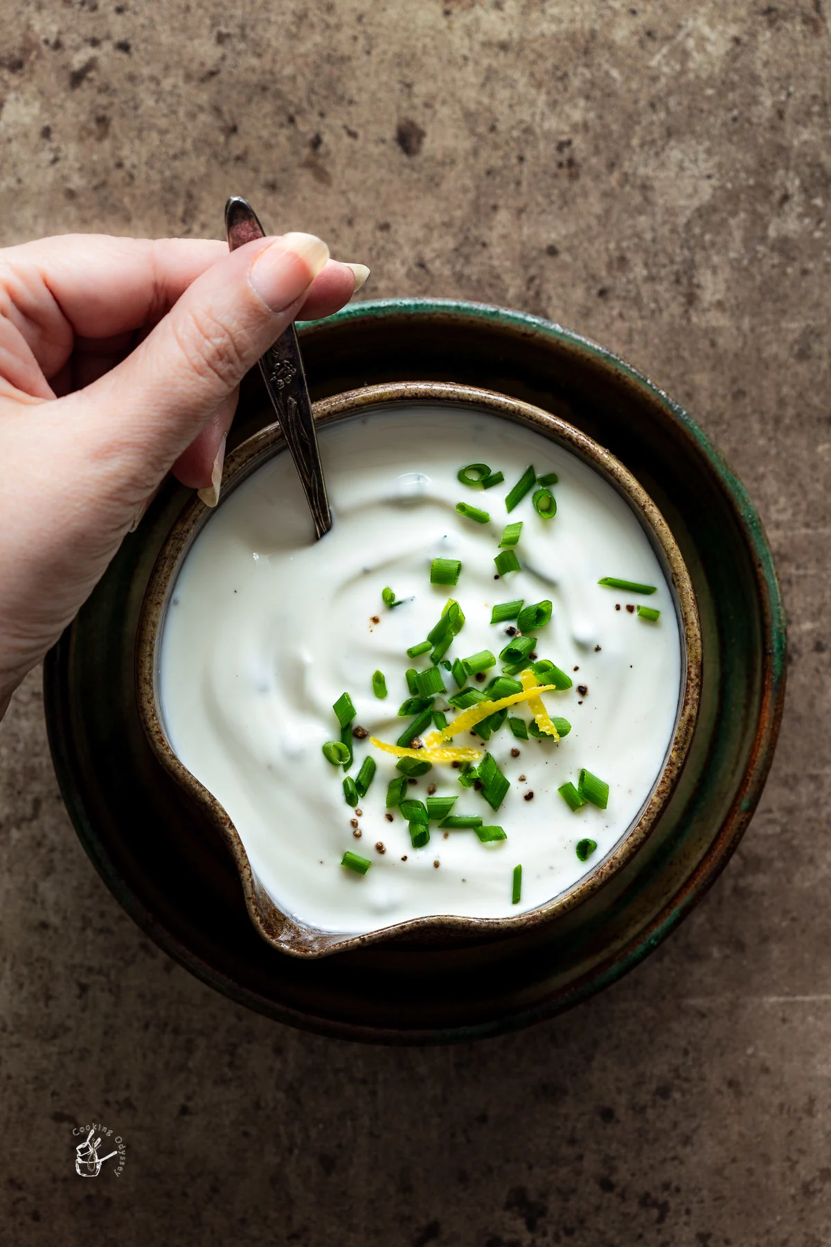 Sour cream and chive dip in a small bowl.