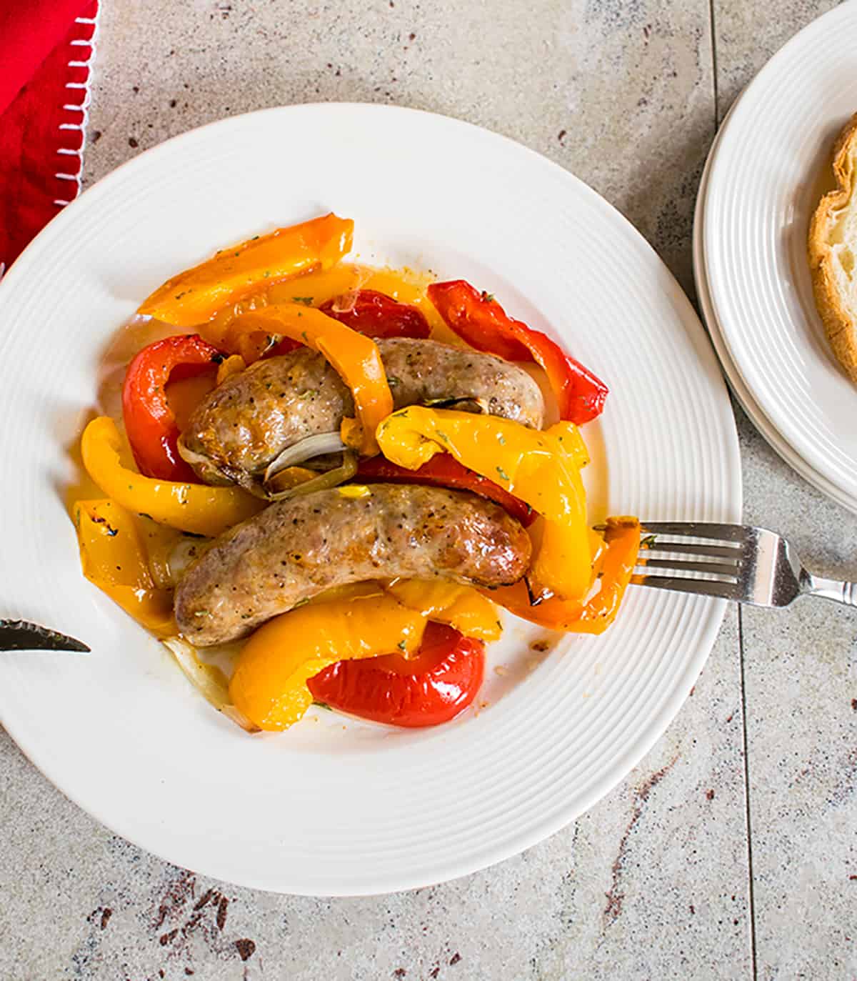 A plate of italian sausage and peppers. 