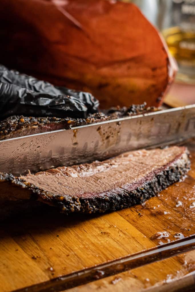 A smoked brisket being cut.