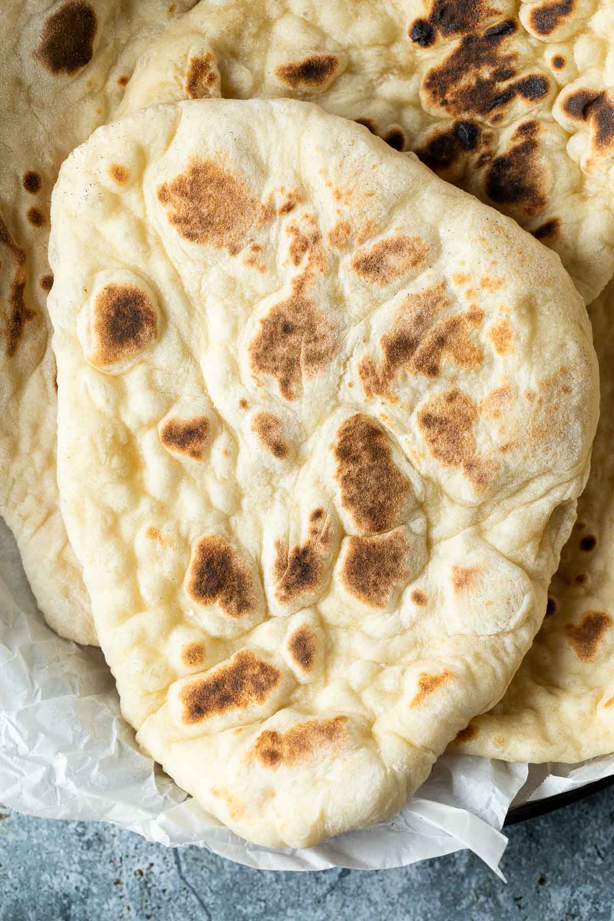 A stack of naan on a plate.
