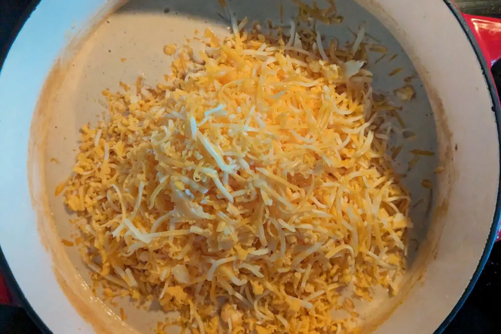 Shredded cheese added to the cheese sauce.