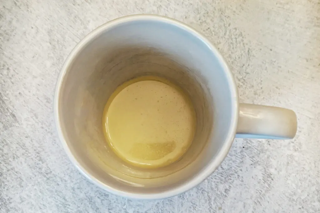Melt butter in the bottom of a mug.