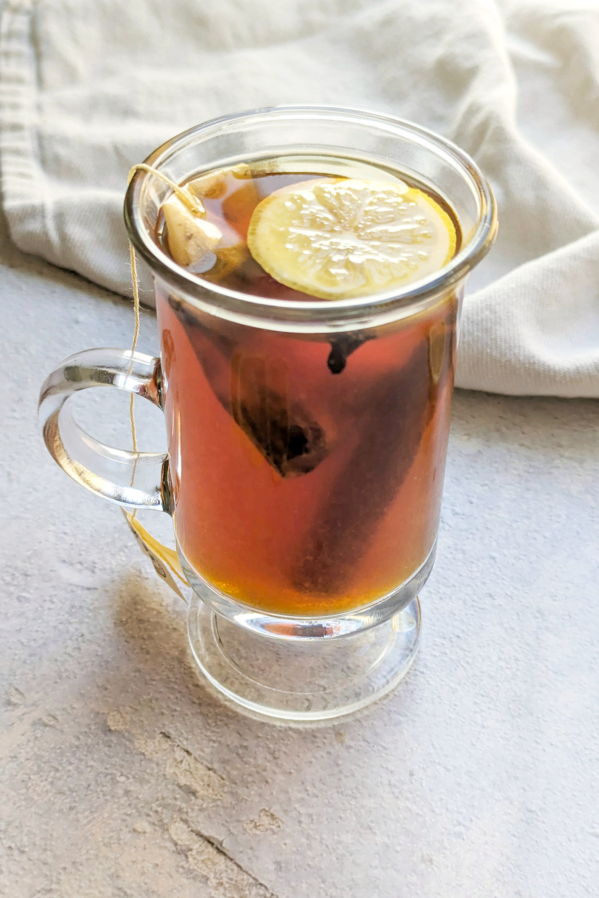 A non alcoholic hot toddy in a glass with lemon.