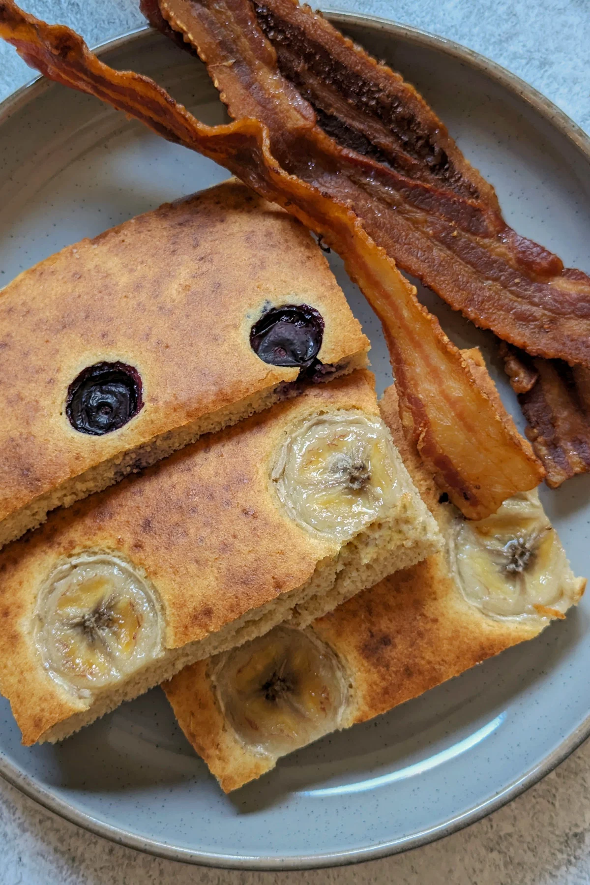 Sheet pan pancakes from mix with bananas and blueberries.