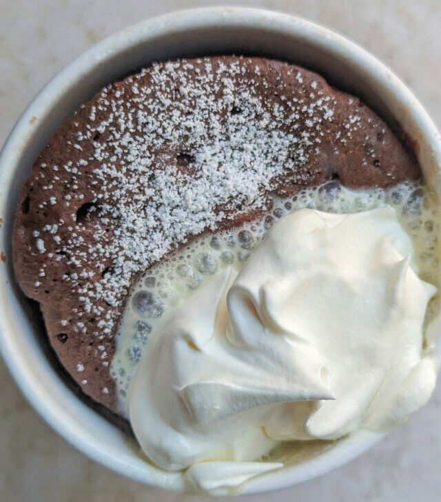 A hot chocolate mug cake with a spoon.