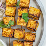 Air fryer paneer on a plate with jeera rice.