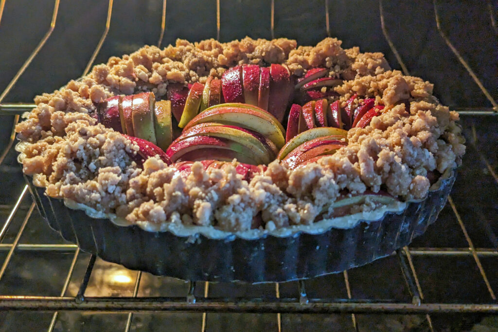 Apple tart crumble baking in the oven.