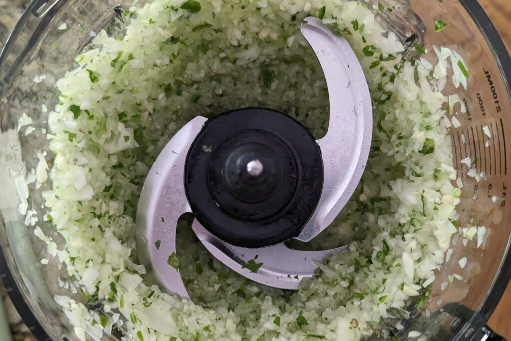Onions and peppers in a food processor.