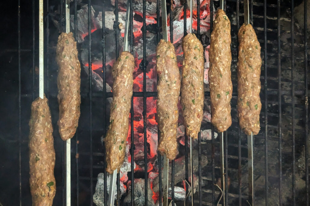 Beef seekh kabobs on the grill.