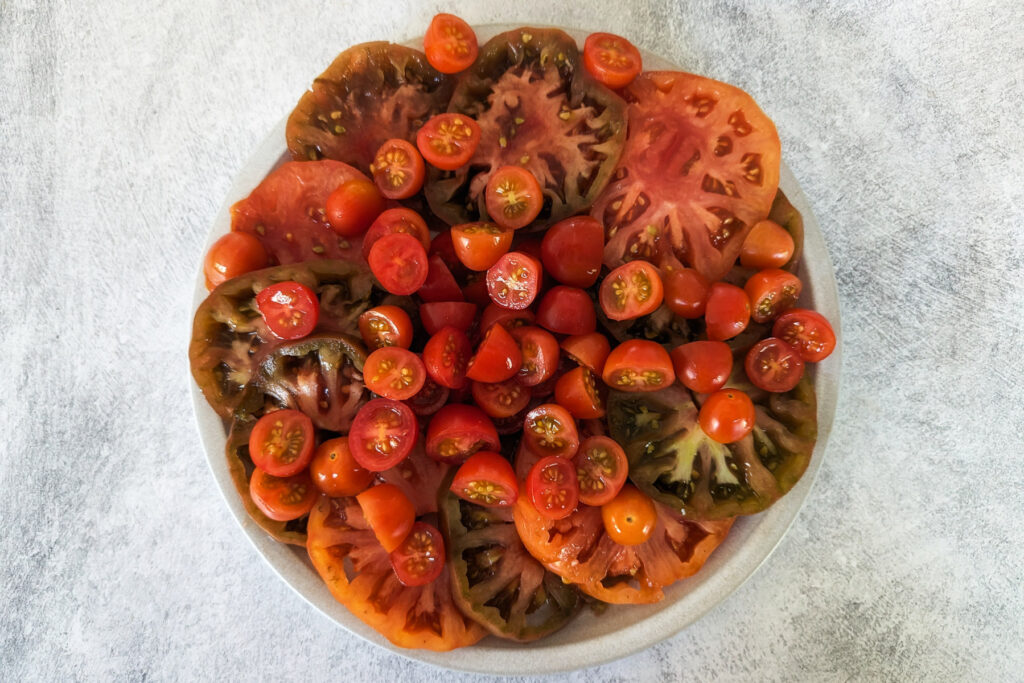 Tomatoes arranged onto a plate.