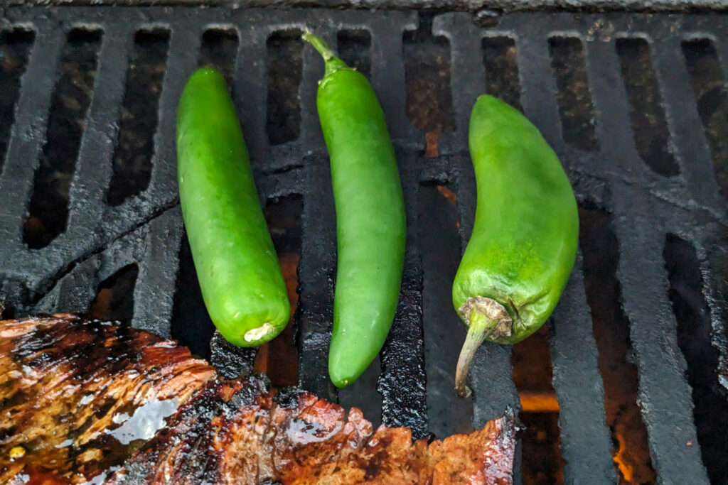 Jalapeños grilling on grill.
