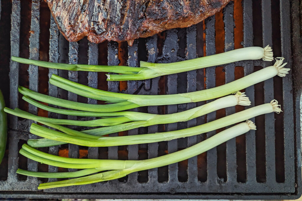 Scallions grilling on the grill.