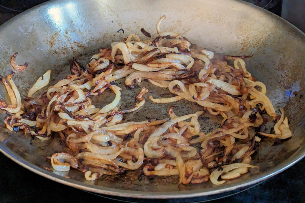 Onions sautéing in a pan.