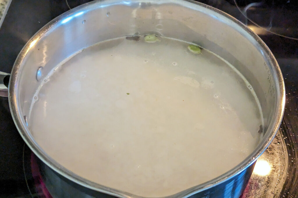 Rice cooking in a saute pan.