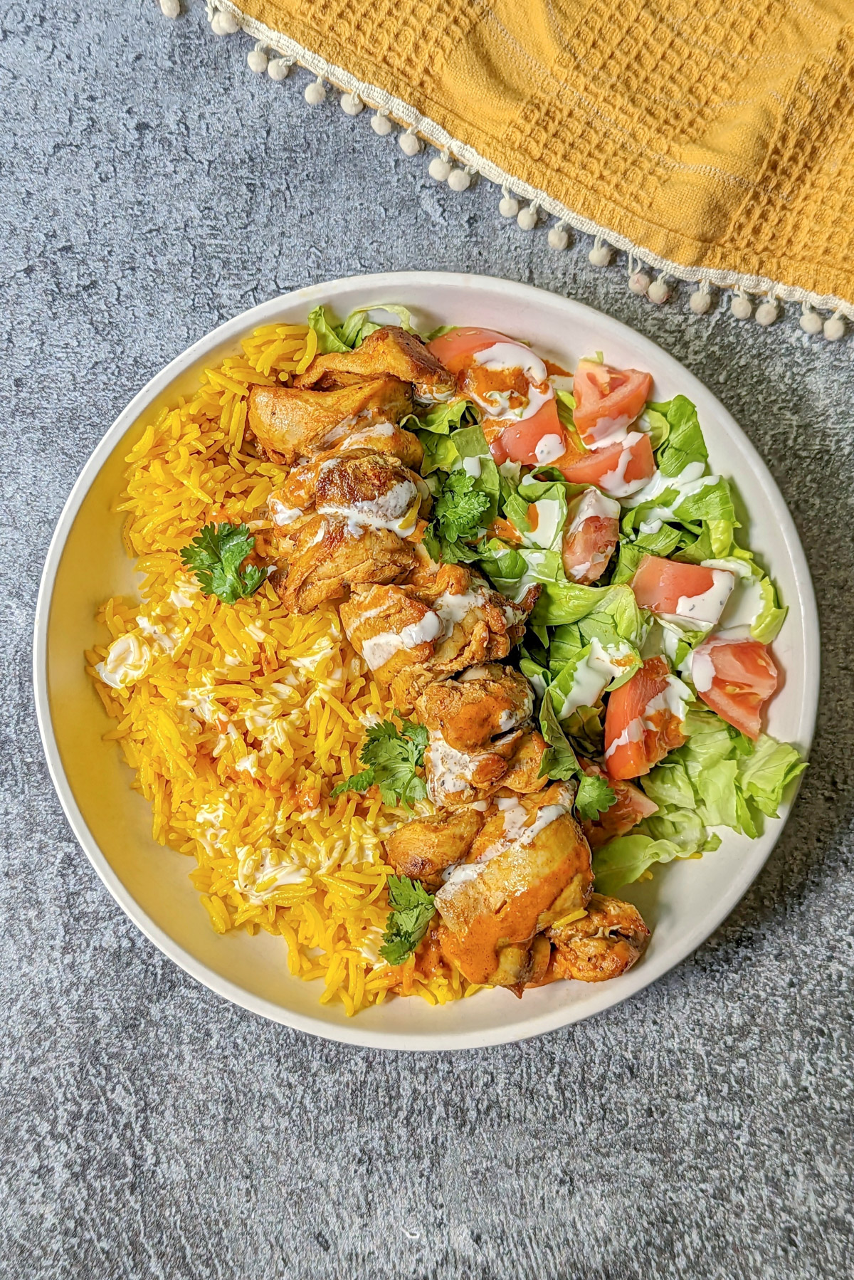 Halal chicken with rice and a salad.