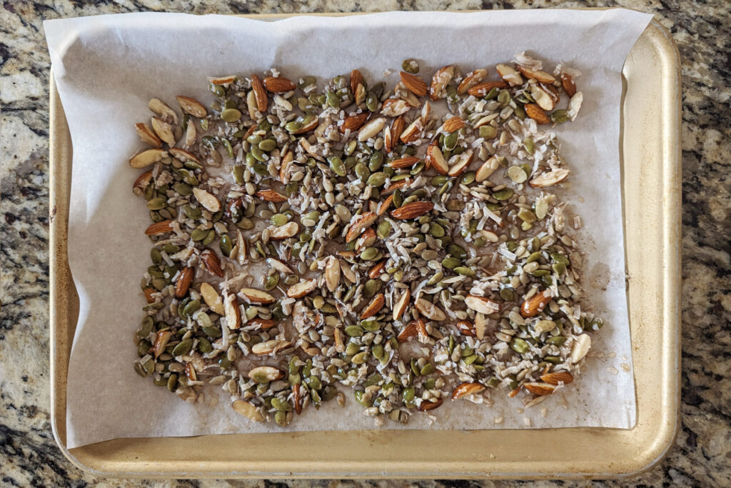 Low fodmap granola spread onto a baking sheet.
