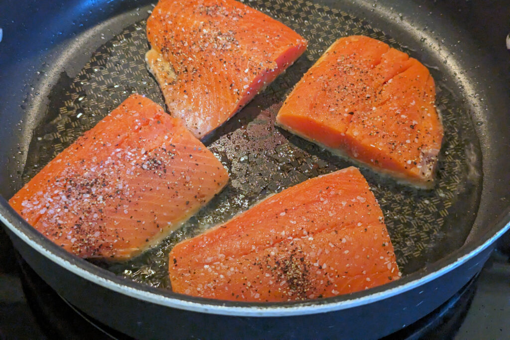 Salmon Searing in a pan.