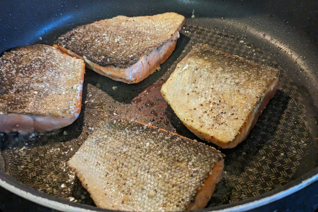 Salmon Searing in a pan.