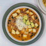 Picadillo Soup in a bowl with toppings.