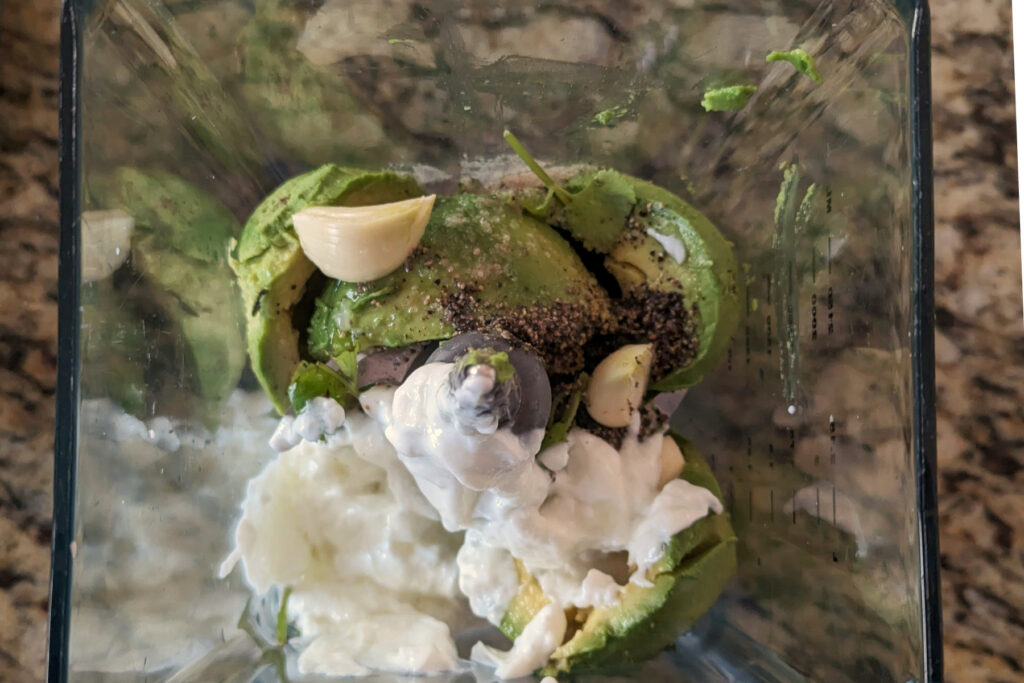 Ingredients for Avocado Lime Crema in a blender.