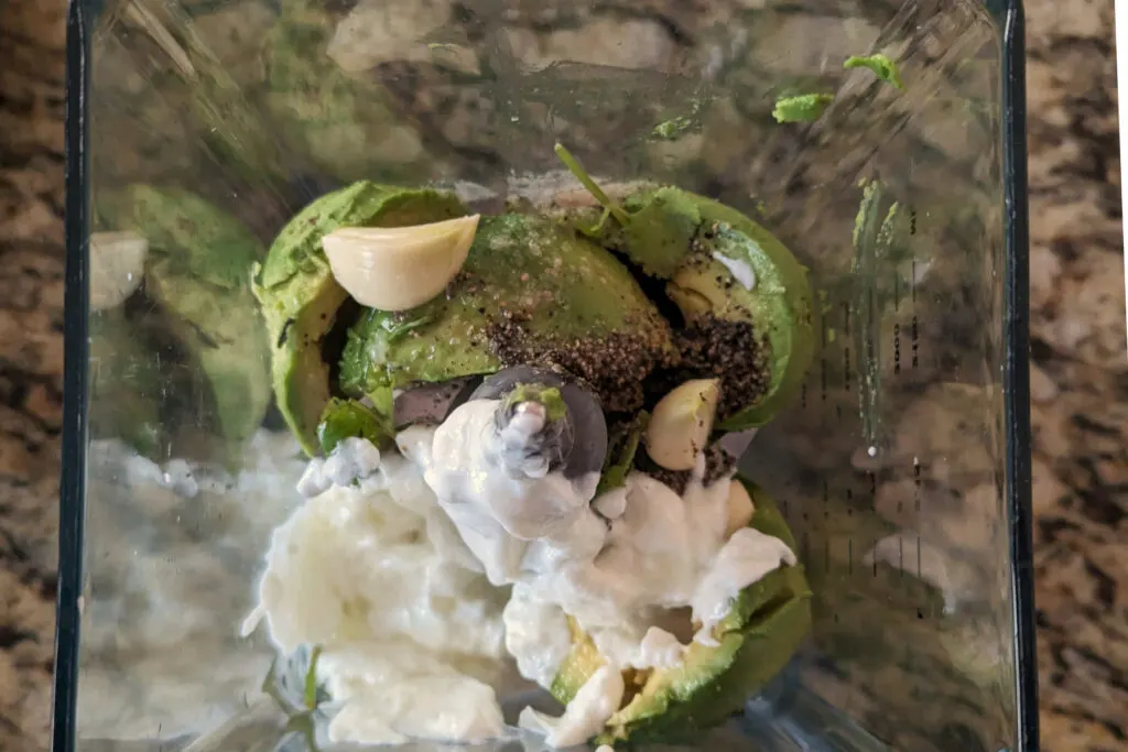 Ingredients for Avocado Lime Crema in a blender.