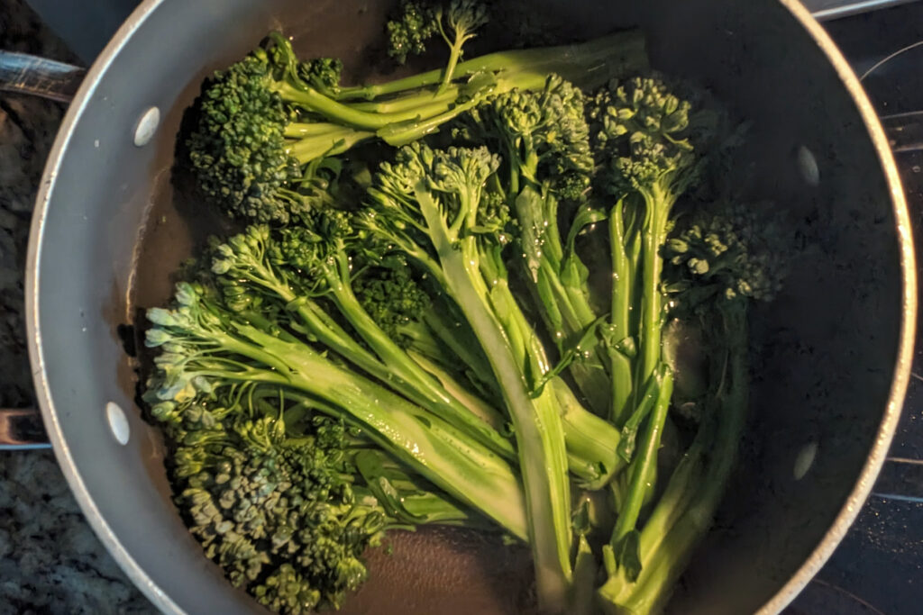 Broccoletti blanching in a pot.