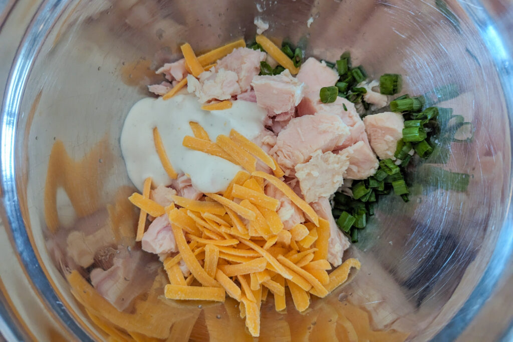 Chicken mixture in a mixing bowl.