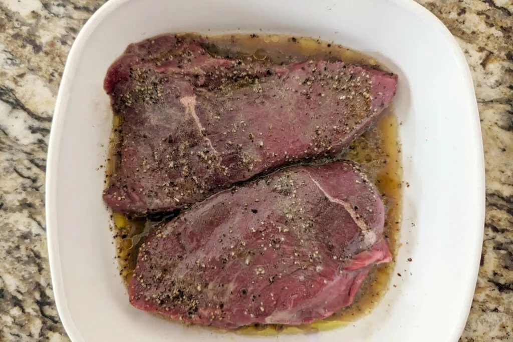 Grilled bison steak marinating.