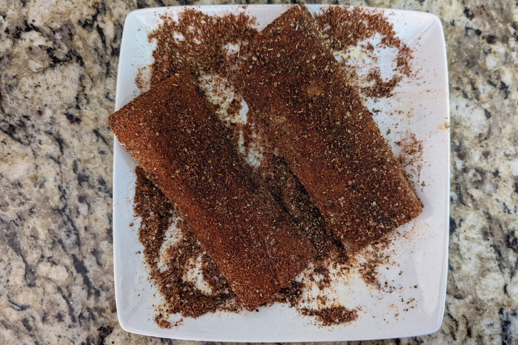 Fillets coated with blackened seasoning.