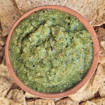 Salsa Verde with Tomatillo in a dish with chips.