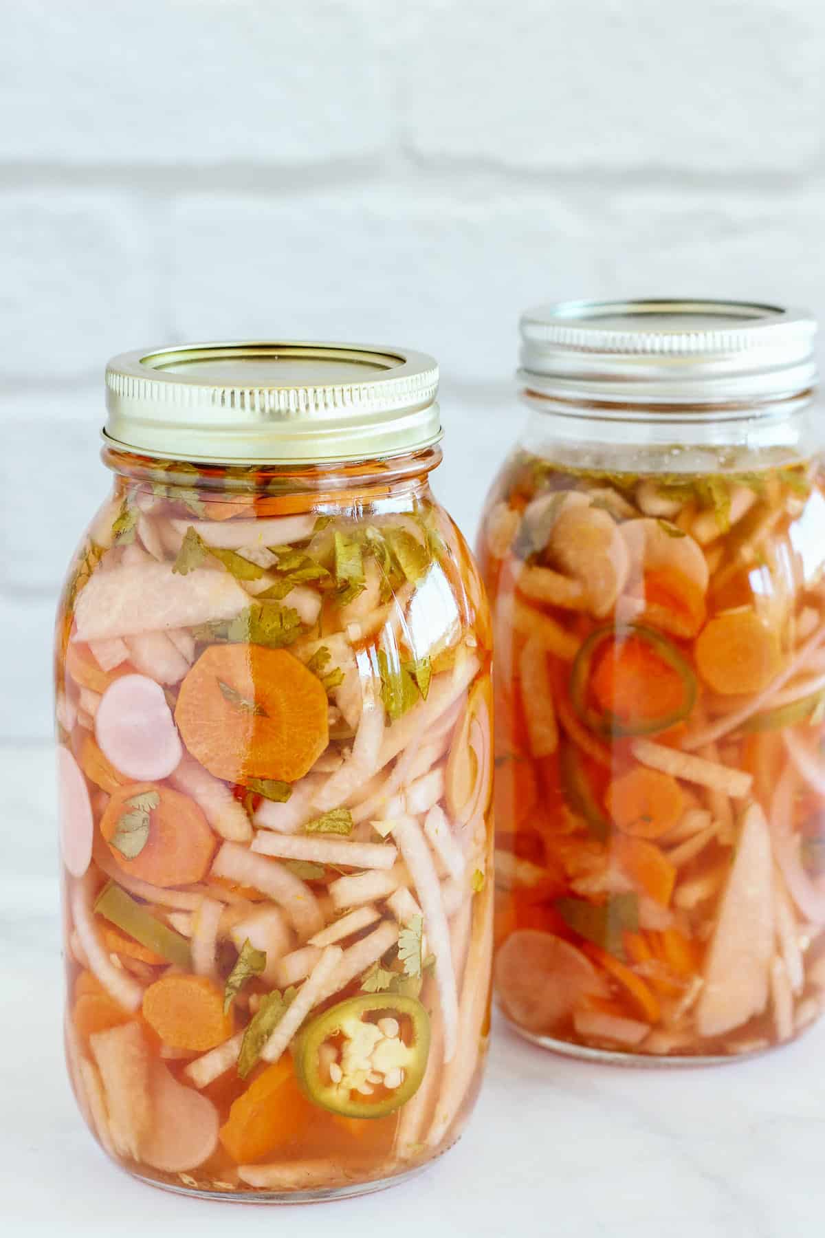 Two cans of mexican pickled vegetables.
