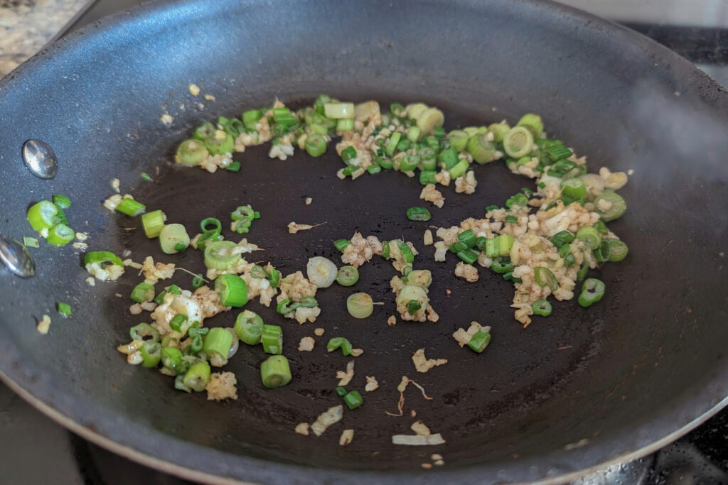Garlic, green onions, and ginger in a skillet.
