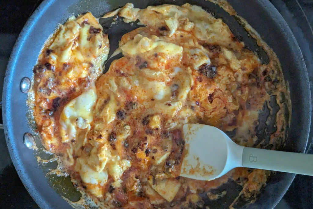 Scrambled eggs in a pan.