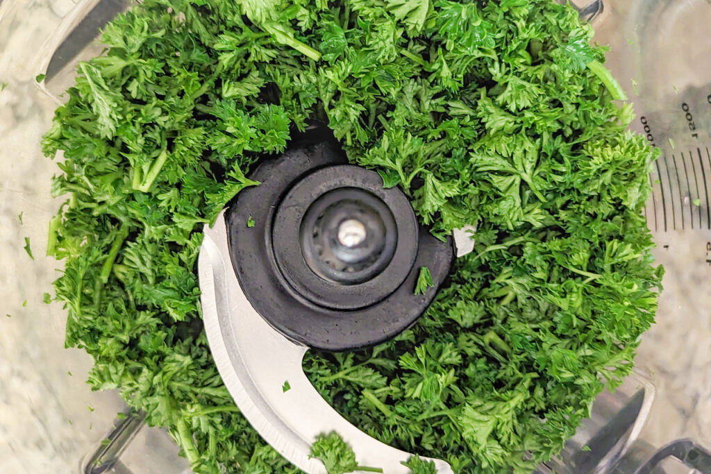 Greens in a food processor bowl.