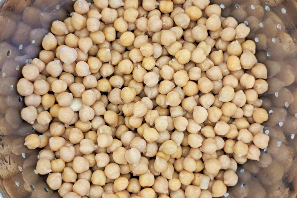 Soaked chickpeas in a colander.