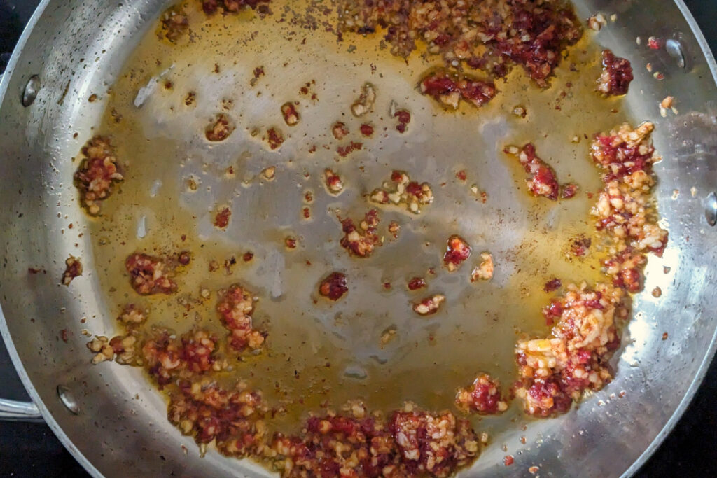 Garlic and tomato paste in a pan.