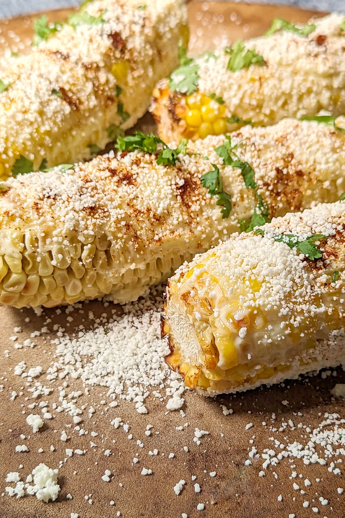 Elotes Mexicano on a serving plate.