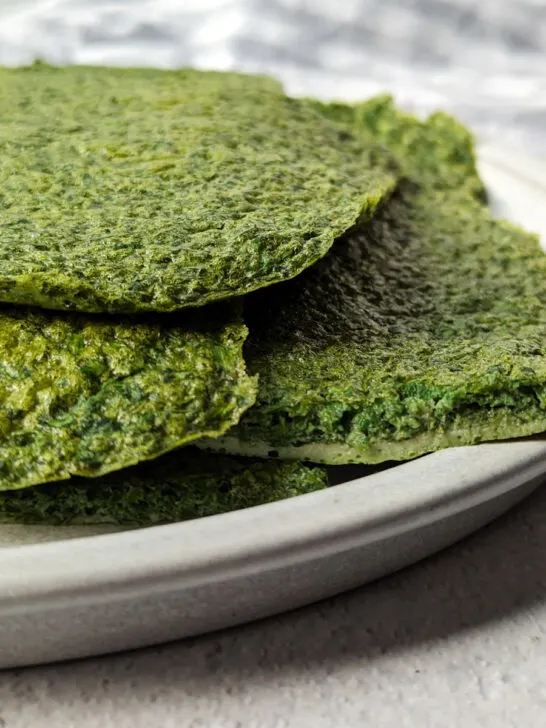 Spinach protein wraps on a plate.