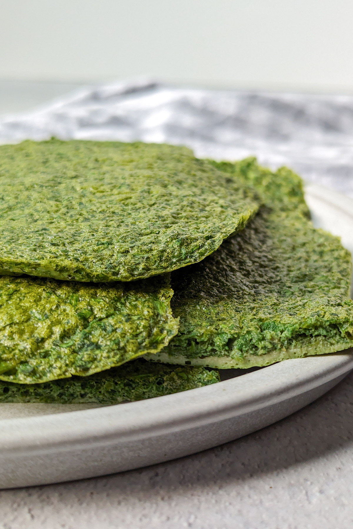 Spinach protein wraps on a plate.