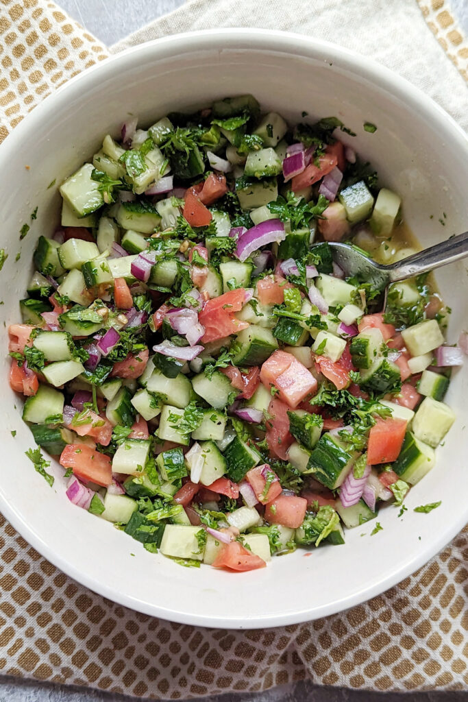 Chopped vegetables with dressing in a bowl. 