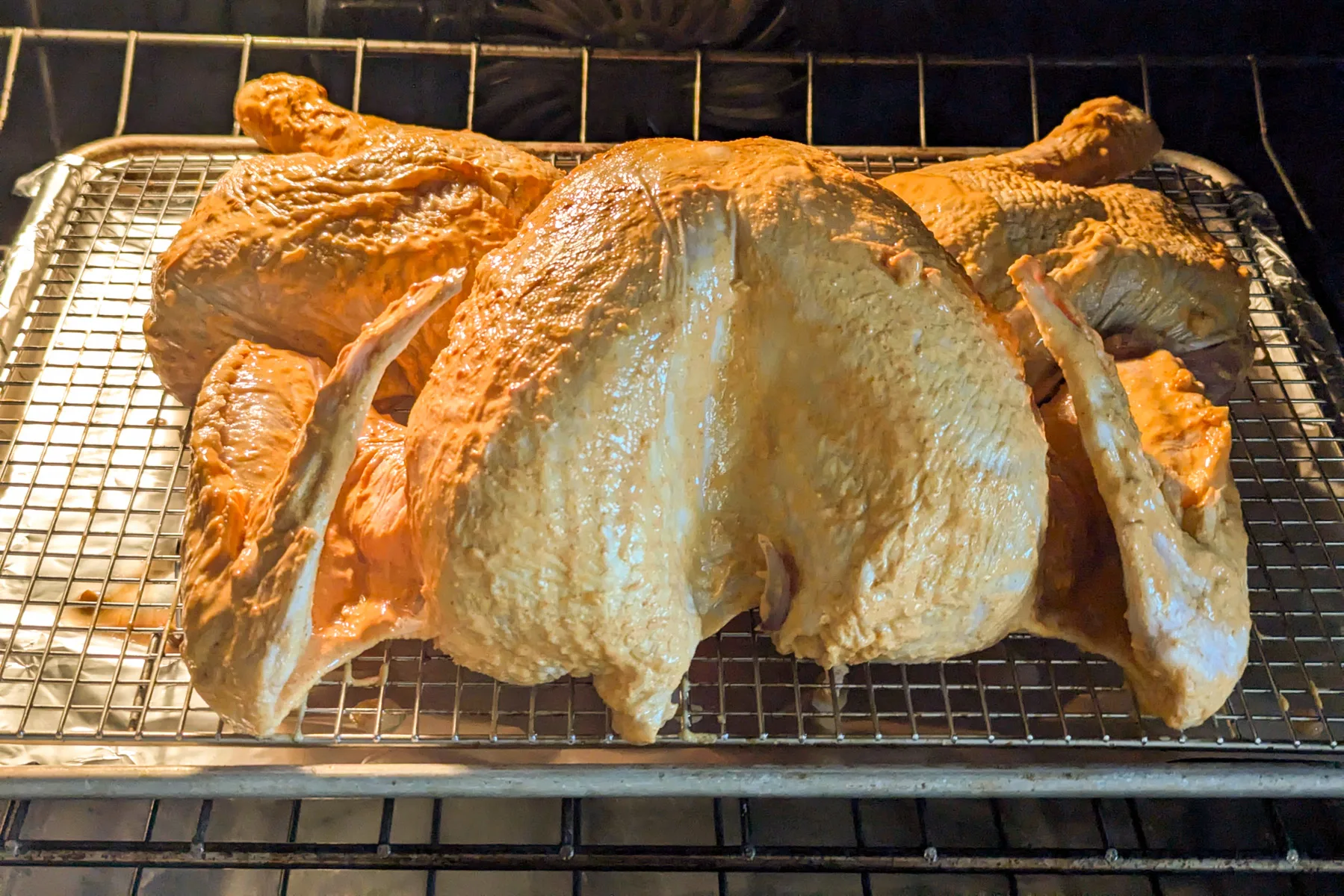 A turkey baking in the oven.