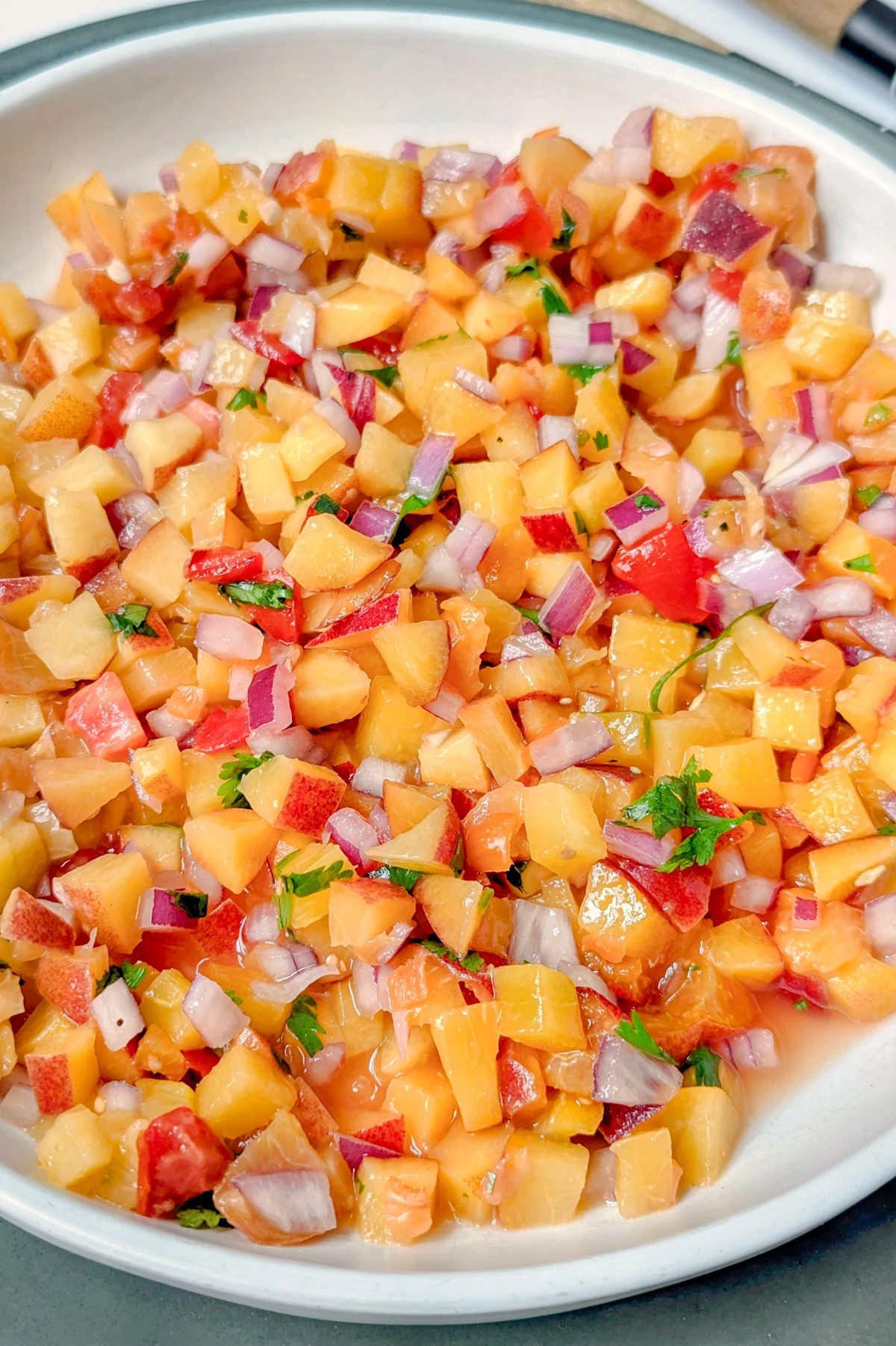 Peach habanero salsa in a serving bowl.