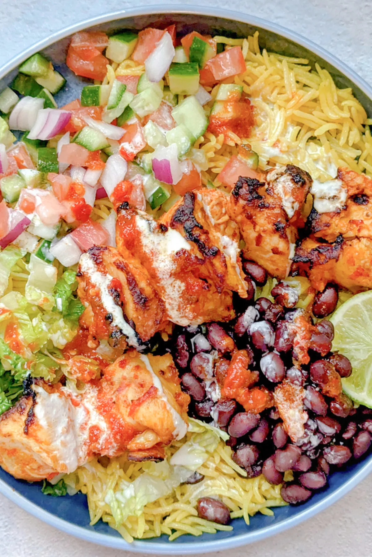 Peri peri chicken bowl on a plate.